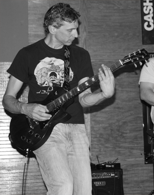 man playing guitar, black and white